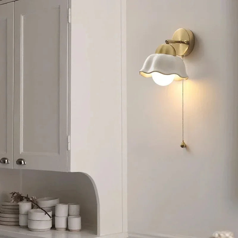 Wall lamp with wavy shade and chain