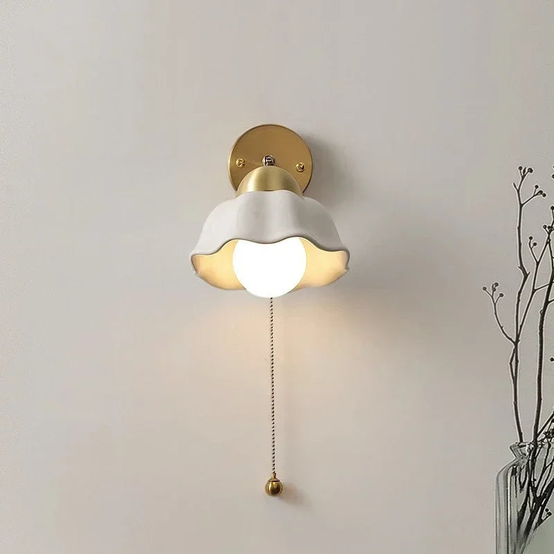 Wall lamp with wavy shade and chain