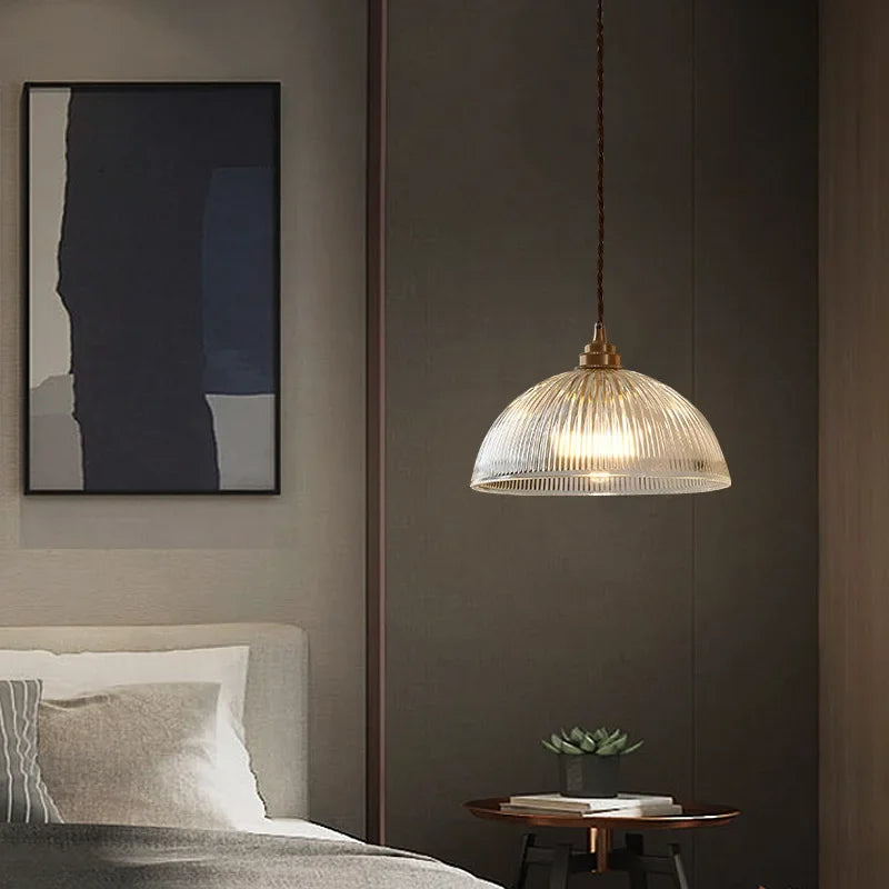 Retro-style glass pendant lamp with an embossed shade and brass finish