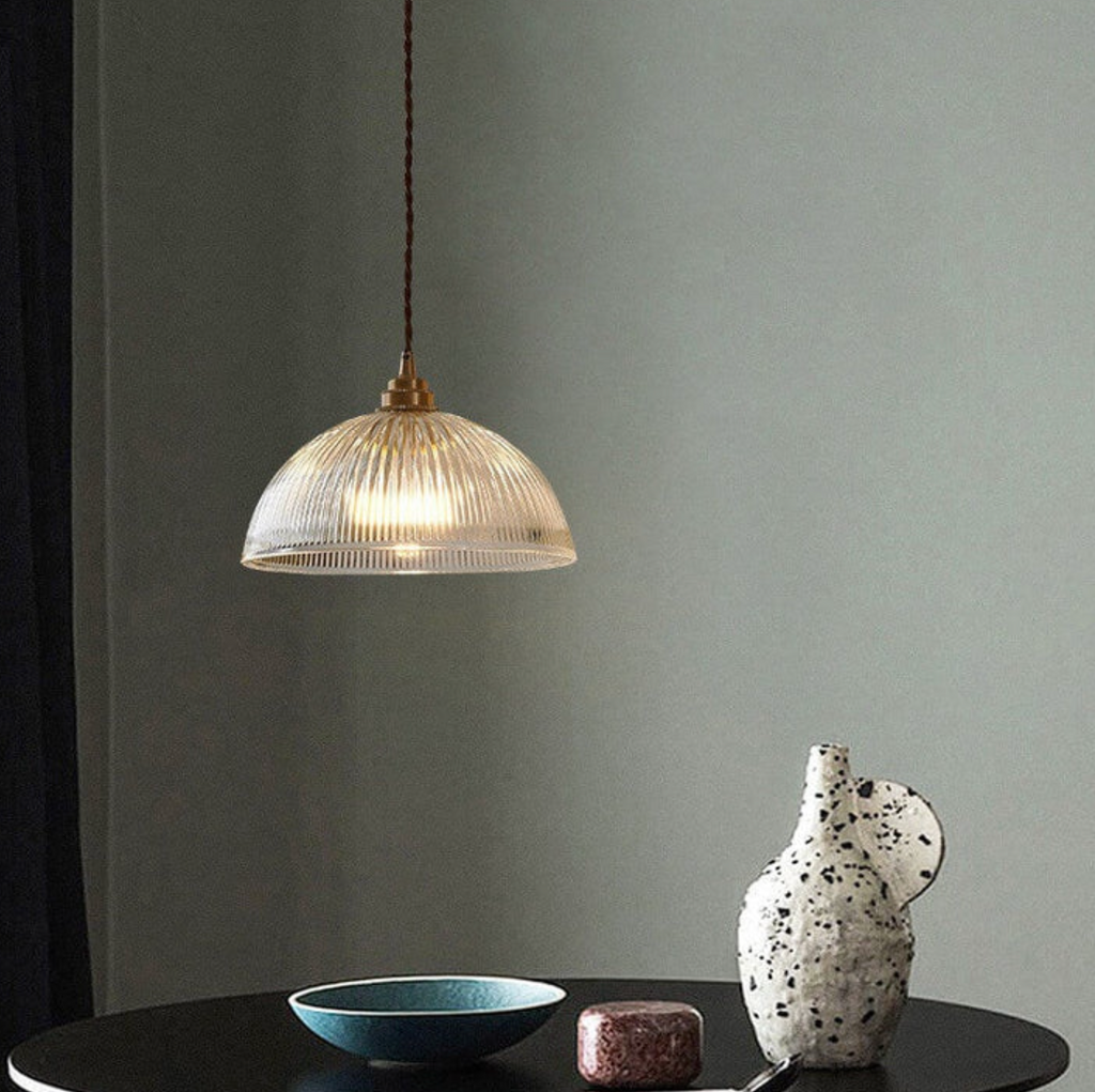 Retro-style glass pendant lamp with an embossed shade and brass finish