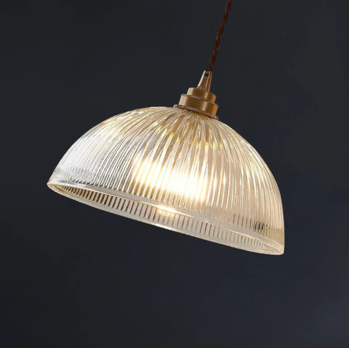 Retro-style glass pendant lamp with an embossed shade and brass finish