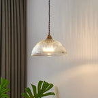 Retro-style glass pendant lamp with an embossed shade and brass finish